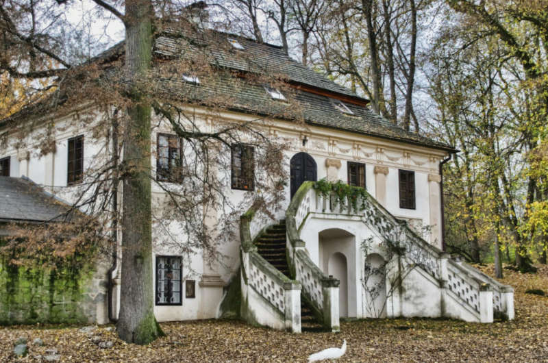 Historisches Haus mit Treppe im herbstlichen Wald